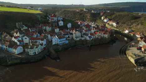 Establishing-Drone-Shot-Over-Staithes-Coastal-Village-on-Sunny-Day-UK