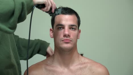 Woman-Cutting-Man's-Hair-Using-Electric-Razor---Close-Up