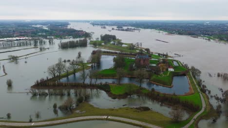 Drone-footage-of-Slot-Loevestein-and-landscape-in-floodwaters-around-River-Waal,-Netherlands