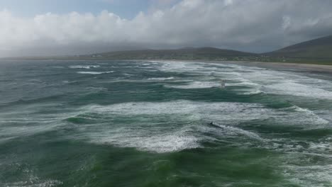 Kitesurfer-braves-tumultuous-ocean-at-Keel-Beach,-Achill-Island
