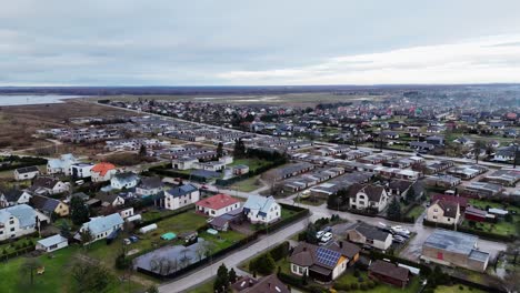 Panoramic-aerial-overview-of-European-suburbs-and-trailer-home-units-under-grey-sky