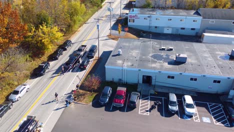 An-establishing-drone-shot-overlooking-a-manhunt-operation-by-law-enforcement-and-police-officers-looking-to-arrest-a-suspect-involved-in-a-shooting-in-Lewiston,-Maine,-USA