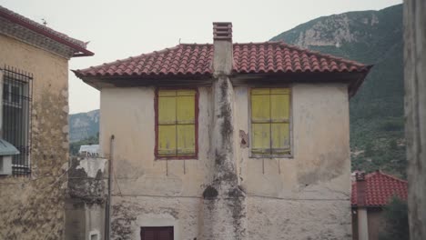 Statische-Ansicht-Der-Mit-Brettern-Vernagelten-Fenster-Im-Alten-Gebäude-Der-Mediterranen-Stadt,-Leonidio,-Griechenland