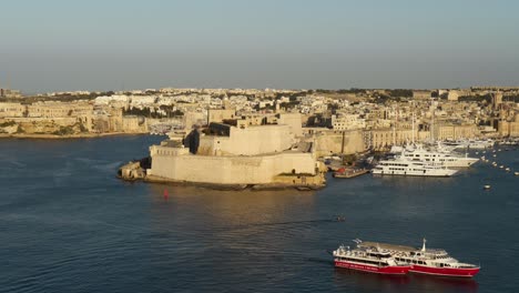 Cruise-Ships-Floating-In-Front-Of-Fort-Saint-Angelo-In-Golden-Hour