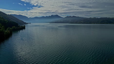 Aerial-view-of-Attersee-Lake-in-Austria-with-distant-mountains-and-clear-skies