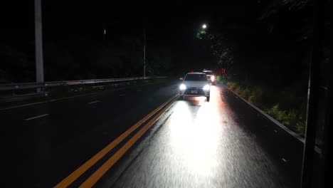 Cars-driving-downhill-from-Coi-Suthep-Chiangmai-during-a-tropical-storm-at-night