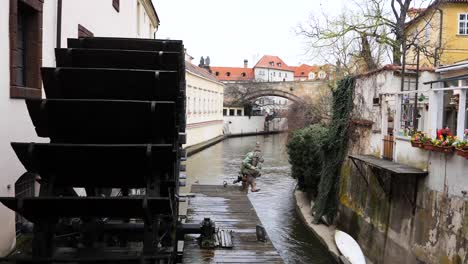 Houses-along-the-Devil´s-Stream-and-the-Wooden-wheel-of-Grand-Priory-Mill-Prague,-Czech-Republic