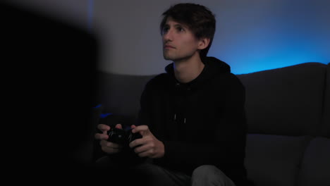 Young-Man-On-Couch-Playing-Video-Games,-Medium-Shot