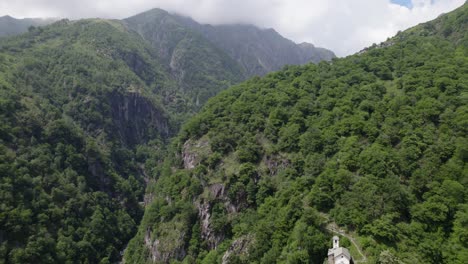 Remote-church-in-scenic-mountain-forest-gorge-landscape-Italy-DRONE-REVEAL