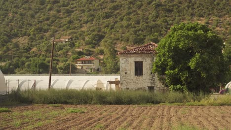 Mediterranean-town-farmland-field-with-steep-dry-shrubs-on-hillside,-static