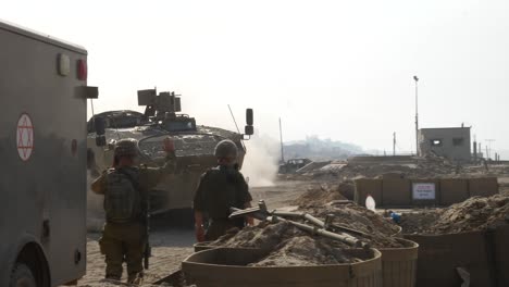 IDF-soldier-directs-a-tank-to-turn-a-road-corner-during-a-military-operation-in-the-Gaza-Strip,-Palestine
