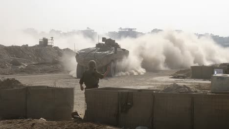 An-IDF-soldier-directs-a-tank-to-turn-a-road-corner-during-a-military-operation-in-the-Gaza-Strip,-Palestine