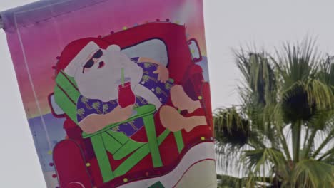 Street-banner-featuring-Santa-Claus-in-downtown-Palm-Springs,-California-with-stable-video-shot