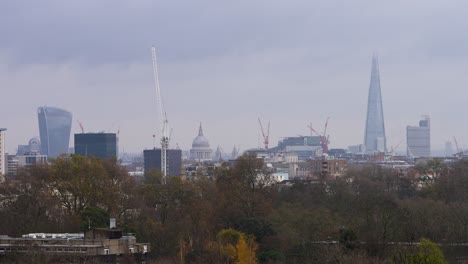 Grey-storm-clouds-set-on-London-city-skyline-with-the-Shard-apartment-building-and-construction-cranes