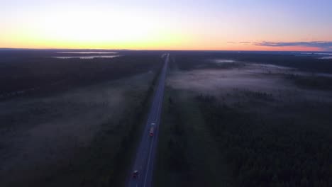 Foggy-morning-drone-shot-over-the-highway-with-a-transport-truck-driving-eastbound