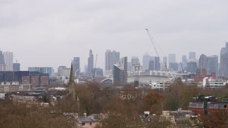 Wide-angle-establishing-pan-across-London-city-skyline-on-overcast-grey-sky-day