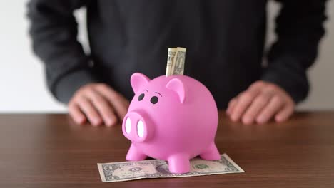 Concept-of-saving-money-in-a-pink-piggy-bank