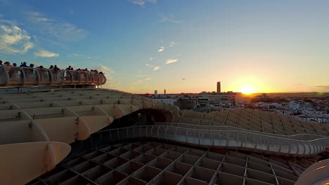 Tourists-watching-sunset-over-Sevilla-from-Metropol-Parasol-in-summer-time