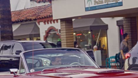 Tilt-down-from-Palm-tree-to-classic-car-in-downtown-Palm-Springs,-California