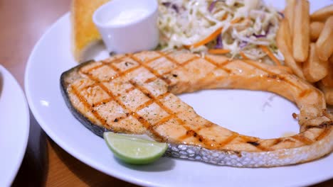 Detail-of-a-beautiful-plate-of-grilled-salmon-fillet-with-fries-and-salad