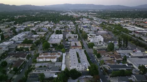 Woodland-Hills-neighborhood-in-the-valley-below-the-Santa-Monica-Mountains---aerial-flyover