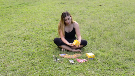 Girl-shuffles-angelic-oracle-tarot-cards-on-green-grass