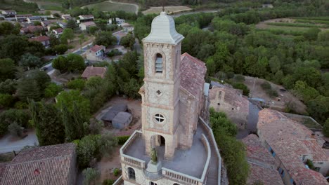 The-chapel-Notre-Dame-de-la-Consolation,-built-in-1894-atop-a-rocky-spur-overlooking-a-village-in-Pierrelongue