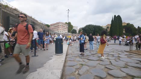 Rome-Immersive-POV:-Moving-In-Busy-Streets-to-Chiesa-Santi-Luca-e-Martina,-Italy,-Europe,-Walking,-Shaky,-4K-|-Family-Walking-As-Large-Crowd-Waits-In-Line