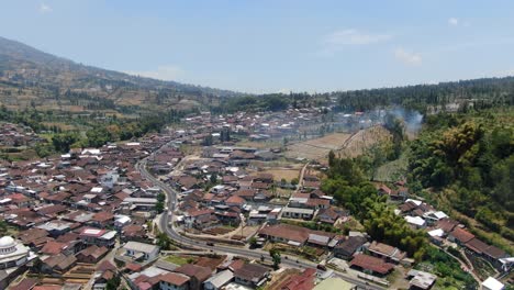 Small-private-homes,-road-and-church-in-township-in-Temanggung,-Indonesia,-aerial-view