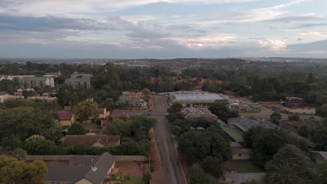 Aerial-footage-of-a-busy-intersection-with-shopping-center-in-Centurion,-Pretoria,-South-Africa