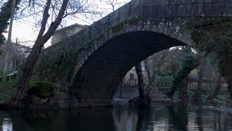 Closeup-view-from-riverbank-of-river-Molgas-and-roman-bridge-made-from-stone