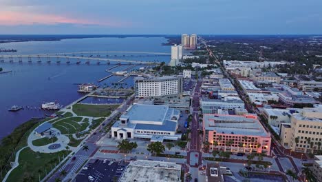 Aerial-flyover-Fort-Myers-City-with-hotel-and-port-during-sunset-time---Caloosahatchee-Bridge-and-Edison-Bridge-in-background