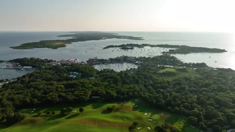 Drone-shot-of-Cape-Cod-with-golf-green,-forests,-and-protected-harbors