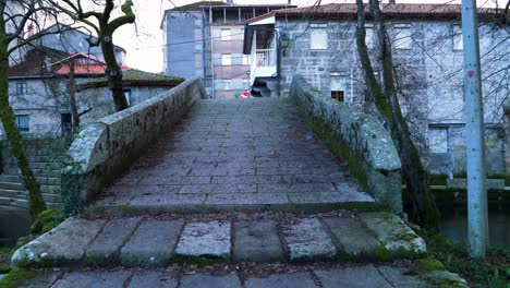 Weathered-stone-steps-of-granite-up-to-river-Molgas-Roman-bridge