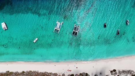 The-drone-is-flying-up-looking-topdown-at-the-boats-and-ships-anchord-at-Little-Curacao-in-Curacao-Aerial-Footage-4K
