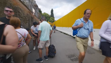 Rome-Immersive-POV:-Moving-In-Busy-Streets-to-Chiesa-Santi-Luca-e-Martina,-Italy,-Europe,-Walking,-Shaky,-4K-|-Line-of-Tourists-Near-Sign-In-Long-Line