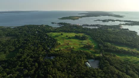 Drone-shot-of-a-golf-course-nestled-in-the-Cape-Cod-landscape
