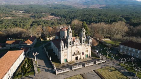 Drone-orbit-around-Gothic-style-cathedral-of-carved-stone-in-Ourense-Spain,-long-shadows