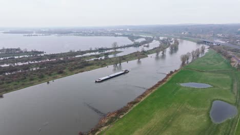 Orbit-shot-moving-towards-the-ship-sailing-over-the-IJssel-with-high-water