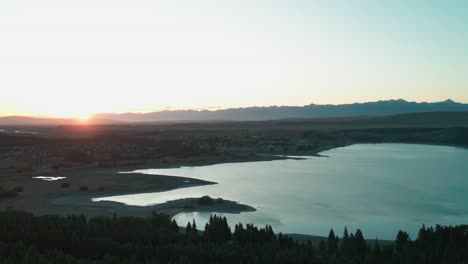 Drone-sunset-over-Lake-Tekapo-with-clear-sky-and-blue-water