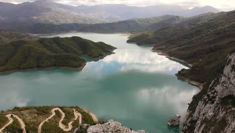 Cinematic-drone-shot-of-The-Bovilla-reservoir-in-the-hills-and-mountains,-Lake-Bovilla,-Albania,-Europe
