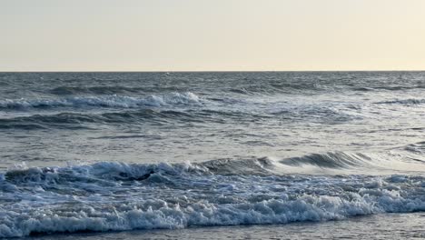 View-of-the-sea-with-small-waves-in-the-breaker-during-sunset