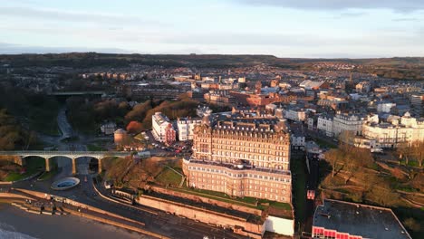 Aerial-top-view-shot-of-beautiful-Grand-Hotel-during-summer-in-Scarborough-North-Yorkshire,-UK-with-city-in-the-background