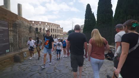 Rome-Immersive-POV:-Moving-In-Busy-Streets-to-Chiesa-Santi-Luca-e-Martina,-Italy,-Europe,-Walking,-Shaky,-4K-|-Family-Walking-Together-Towards-Colosseum