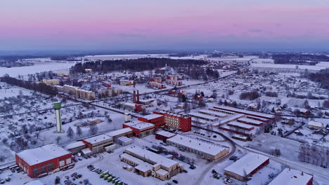 Winter-village-with-a-district-heating-plant-at-dusk---scenic-aerial-view