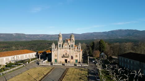Drone-rises-and-tilts-down-to-reveal-Sanctuary-of-Our-Lady-of-Miracles,-Ourense-Spain