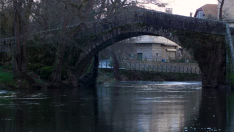 Static-view-of-curved-arch-on-triangular-roman-bridge-crossing-Molgas-River