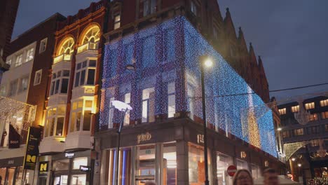 A-beautifully-illuminated-facade-of-a-house-in-the-city-during-the-Christmas-holidays