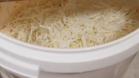 Grate-cabbage-in-the-bucket-for-sauerkraut