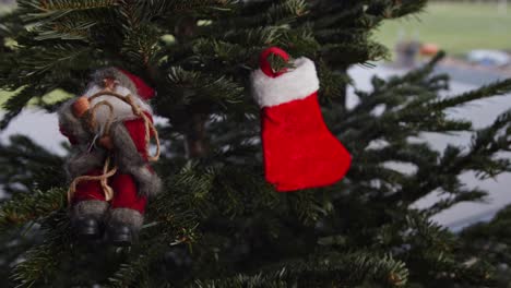 Hanging-Red-Christmas-Stocking-on-Green-Christmas-Tree-4K